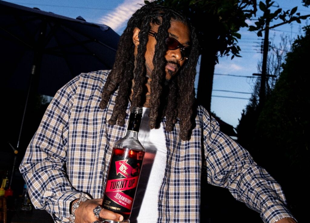 DJ drinking Turnt Up by the Champ at a party