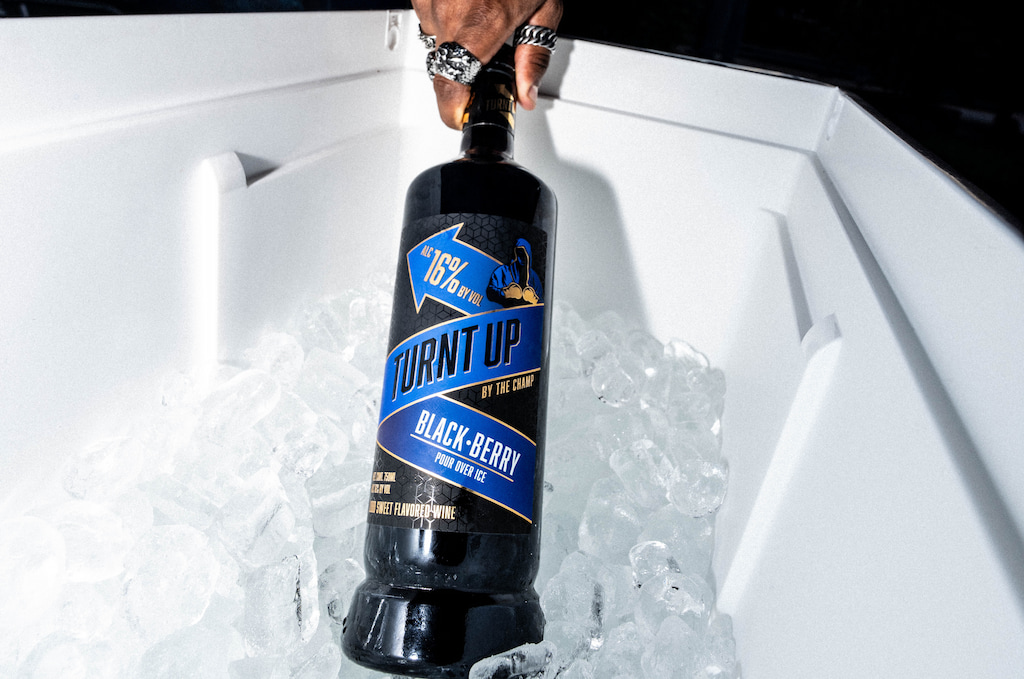 Turnt Up by the Champ Blackberry Wine chilled in a cooler, ready for an outdoor party